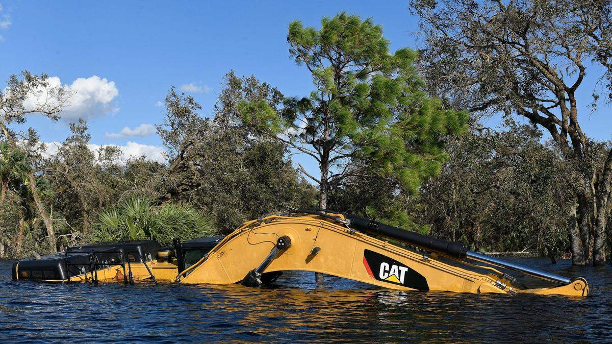 An excavator nearly covered by the flood waters in Venice, Florida. The aftermath of Hurricane Ian has brought more rising floodwaters along the Myakka River and inundated surrounding neighborhoods.