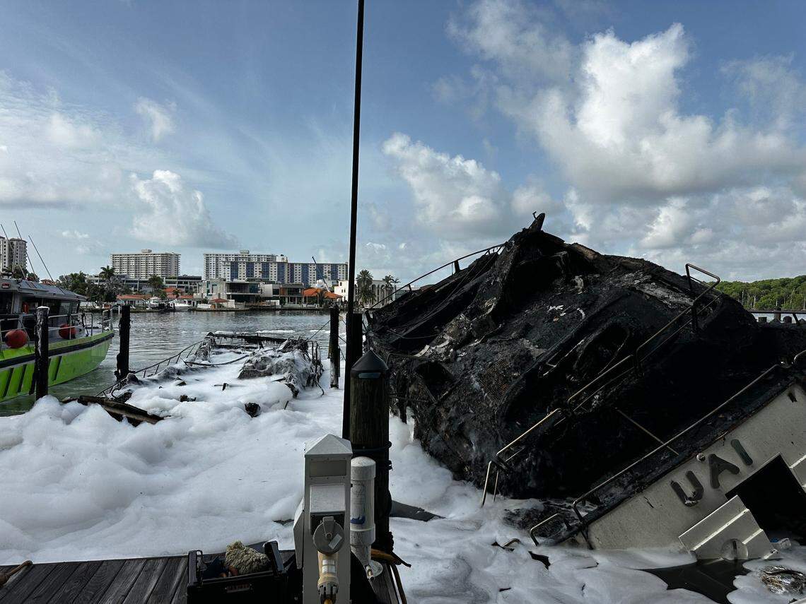 The boat Lupo, covered in white firefighting foam to the left of the charred boat, is owned by Michael Lupolover, the owner of the Lupo Yacht Club in Sunny Isles Beach. ‘It’s my baby,’ he said.
