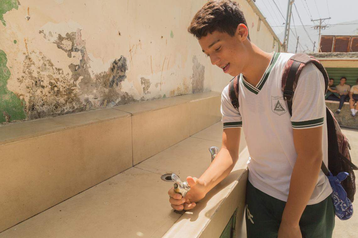 Alejandro Figueroa can't get water at the drinking fountains at Alejandro Oropeza Castillo Adventist Institute. Students have to bring their own water every day or go without. Along with the lack of water, the temperatures are usually very hot.