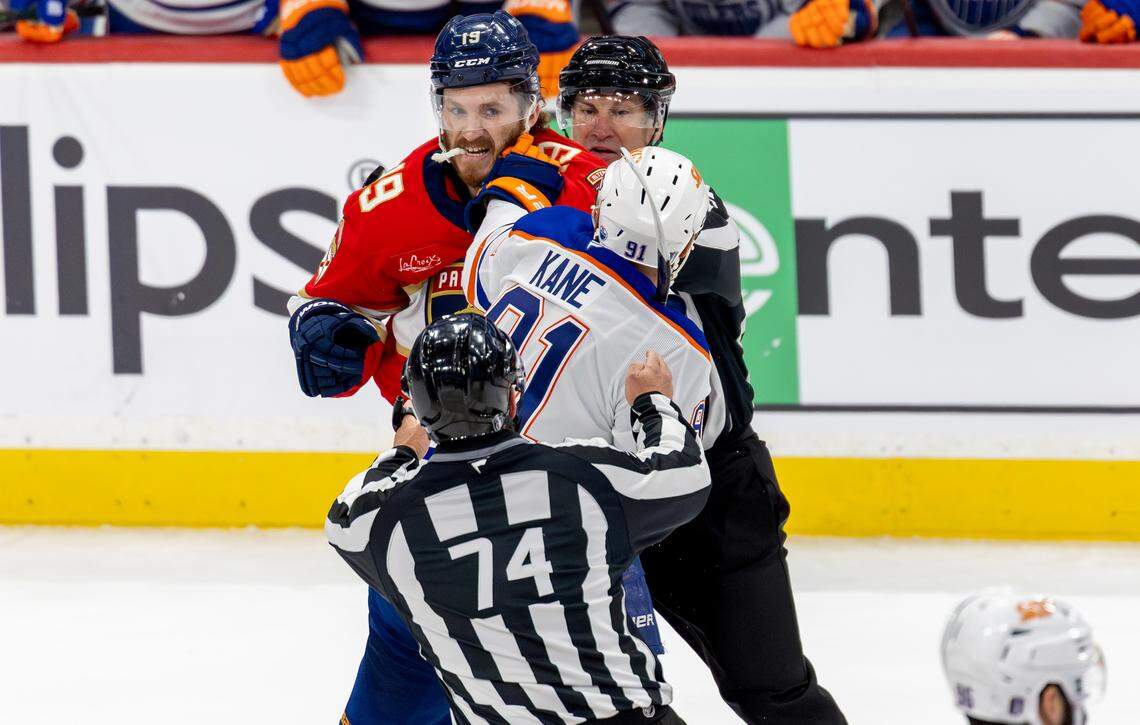 NHL linesmen Scott Cherrey (50) and Trent Knorr (74) attempt to break up a fight between Florida Panthers left wing Matthew Tkachuk (19) and Edmonton Oilers left wing Evander Kane (91) during the first period of Game 3 in the NHL Stanley Cup Final at Amerant Bank Arena on Monday, June 9, 2025, in Sunrise, Fla.