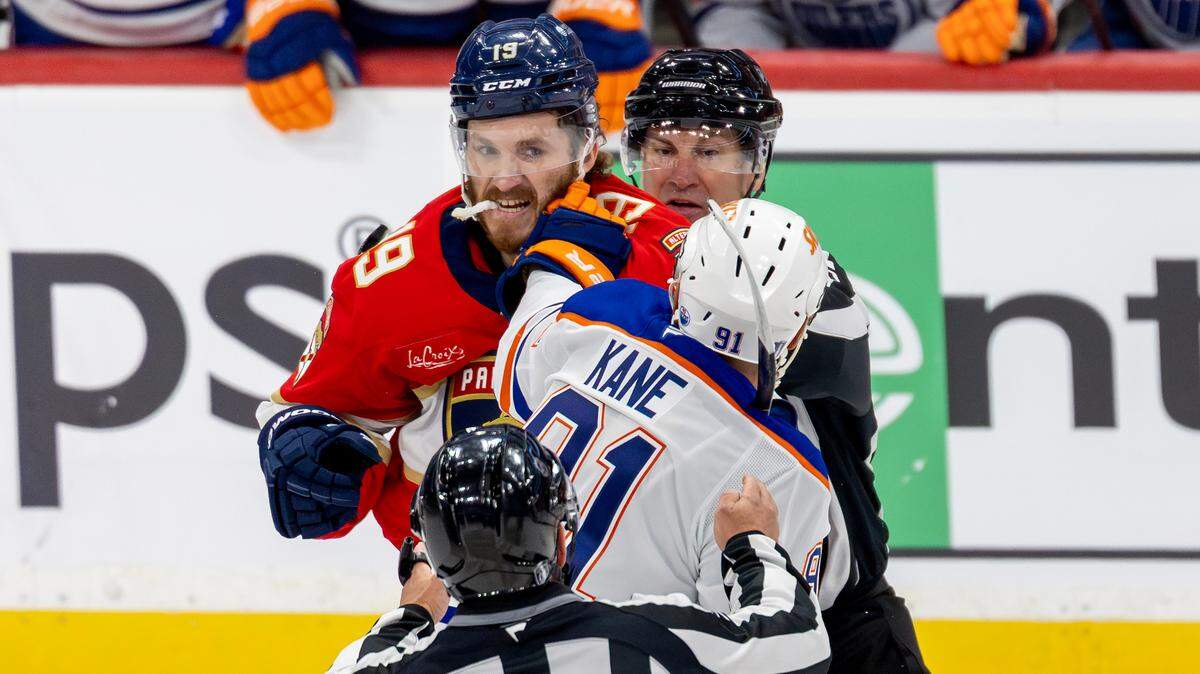 NHL linesmen Scott Cherrey (50) and Trent Knorr (74) attempt to break up a fight between Florida Panthers left wing Matthew Tkachuk (19) and Edmonton Oilers left wing Evander Kane (91) during the first period of Game 3 in the NHL Stanley Cup Final at Amerant Bank Arena on Monday, June 9, 2025, in Sunrise, Fla.