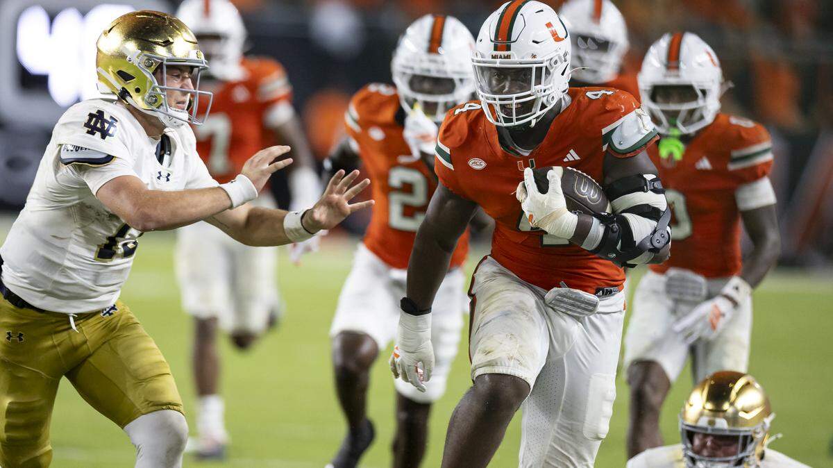 Miami Hurricanes defensive lineman Rueben Bain Jr. (4) runs with the ball after he intercepted the ball against Notre Dame Fighting Irish in the second half of their NCAA football game at Hard Rock Stadium on Sunday, Aug. 31, 2025, in Miami Gardens, Fla.