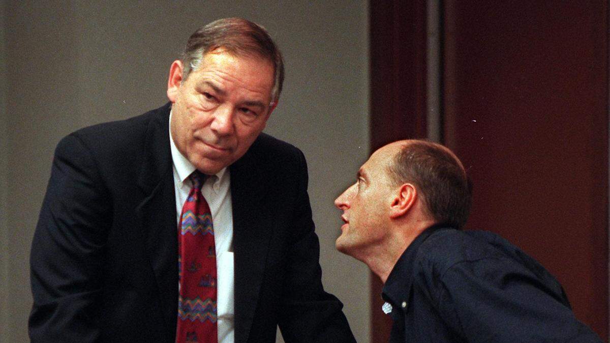 Enrico Forti, right, speaks to his defense attorney, Donald Bierman, in a courtroom at the Richard E. Gerstein Justice Building on Feb. 25, 1998.