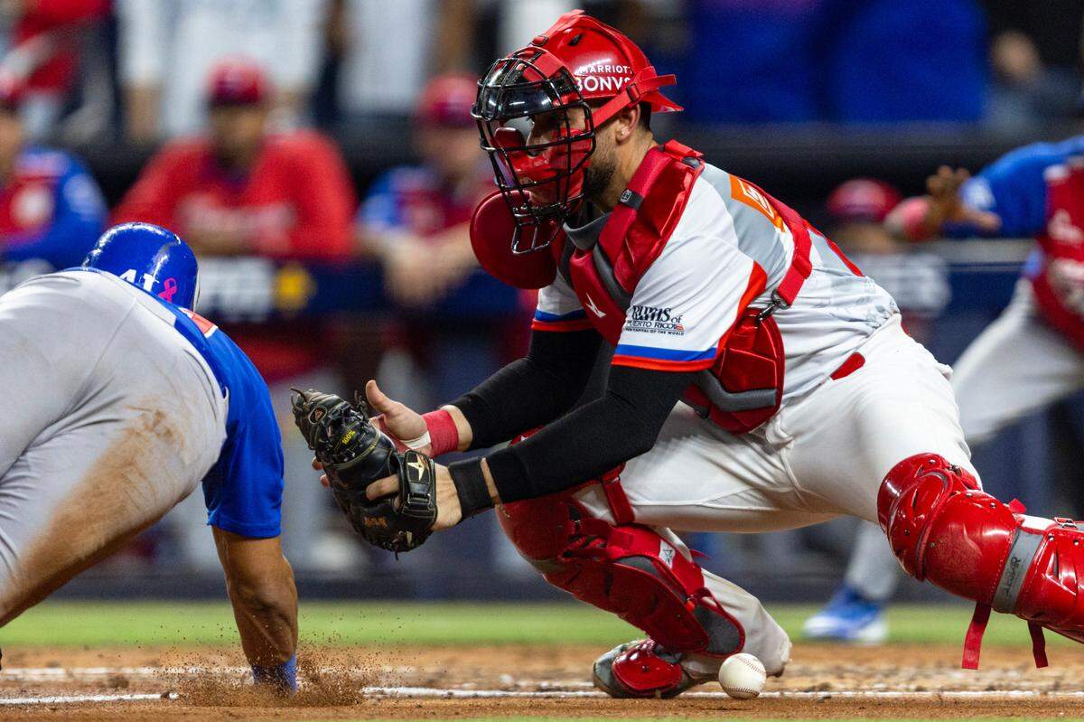 Puerto Rico catcher Juan Escarra (47) fails to tag base runner Ramon Hernandez (41) with the ball to allow a run during the third inning of a Caribbean Series baseball game at loanDepot park in Miami, Florida, on Saturday, February 3, 2024.
