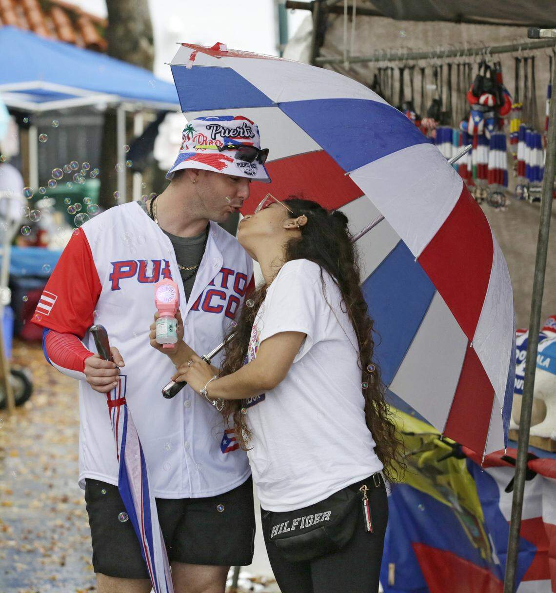 Raydel Becerra of Puerto Rico and his girlfriend Samantha Asmat of Peru share the kiss uring Calle Ocho festival on Sunday, March 15, 2026 in Little Havana. Andrew Uloza / for Miami Herald