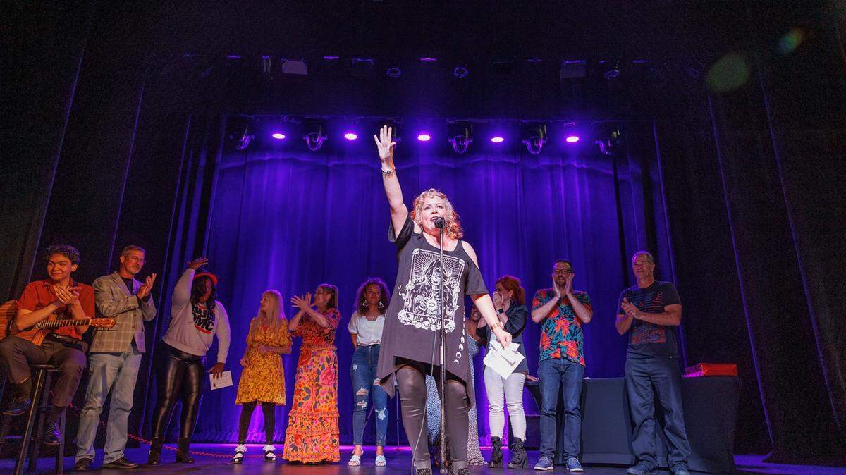 Moth StorySLAM Host Gabriela Fernandez and the GrandSLAM storytellers at last year’s “Fight or Flight” competition. This year, the GrandSLAM is on Friday, Dec. 13 at The Black Archives Historic Lyric Theater.