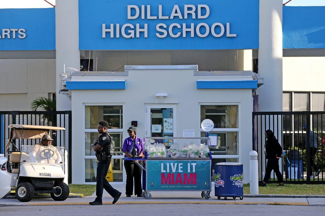 Dillard High School employees wait for students and parents to arrive to get a packaged breakfast in Fort Lauderdale, Florida, March 16, 2020. Broward County schools are closed because of COVID-19 concerns.
