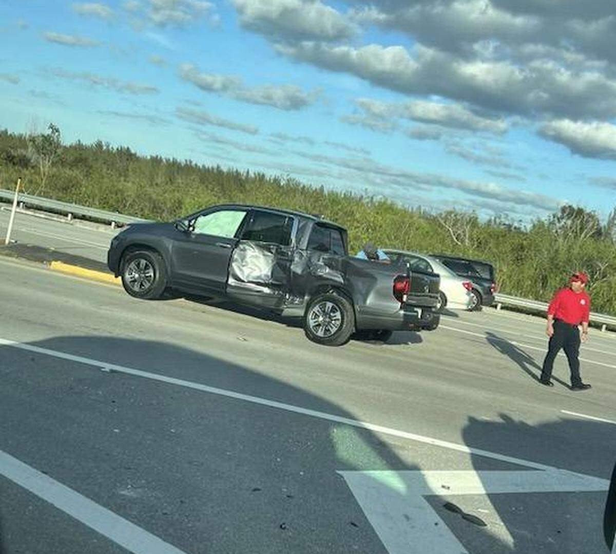 A pickup truck with damage to its left side is parked in the middle of U.S. 1 in Florida City Tuesday, Feb. 27, 2024. A Monroe County Sheriff’s Office patrol car struck the pickup. The sheriff’s office said the pickup pulled out in front of the car, and the deputy did not have time to stop.