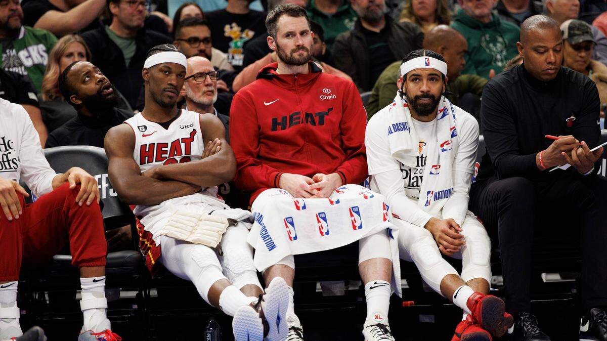 Apr 19, 2023; Milwaukee, Wisconsin, USA; Miami Heat forward Jimmy Butler (22), forward Kevin Love (42) and guard Gabe Vincent (2) look on from the bench during the fourth quarter against the Milwaukee Bucks during game two of the 2023 NBA Playoffs at Fiserv Forum. Mandatory Credit: Jeff Hanisch-USA TODAY Sports