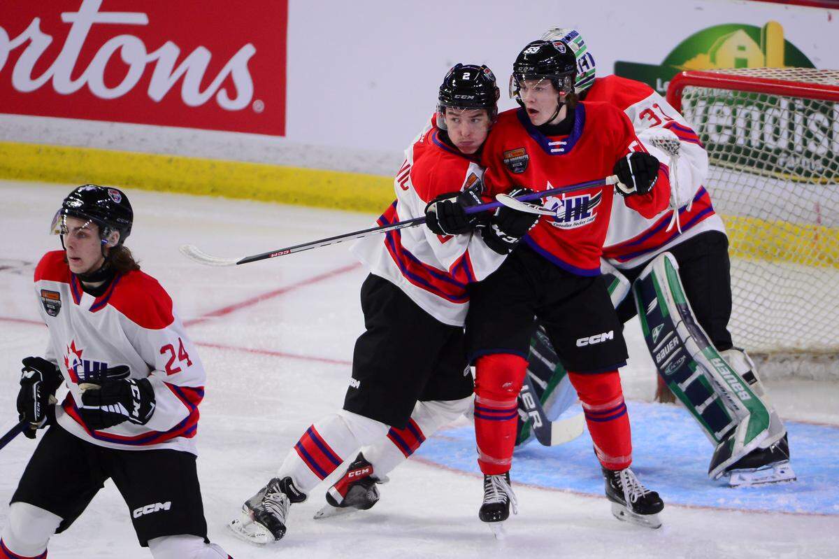 Jan 25, 2023; Langley, BC, CANADA; CHL Top Prospects team white defenseman Lukas Dragicevic (2) defends against CHL Top Prospects team red forward Gracyn Sawchyn (59) during the first period in the 2023 CHL Top Prospects ice hockey game at Langley Events Centre. Mandatory Credit: Anne-Marie Sorvin-USA TODAY Sports