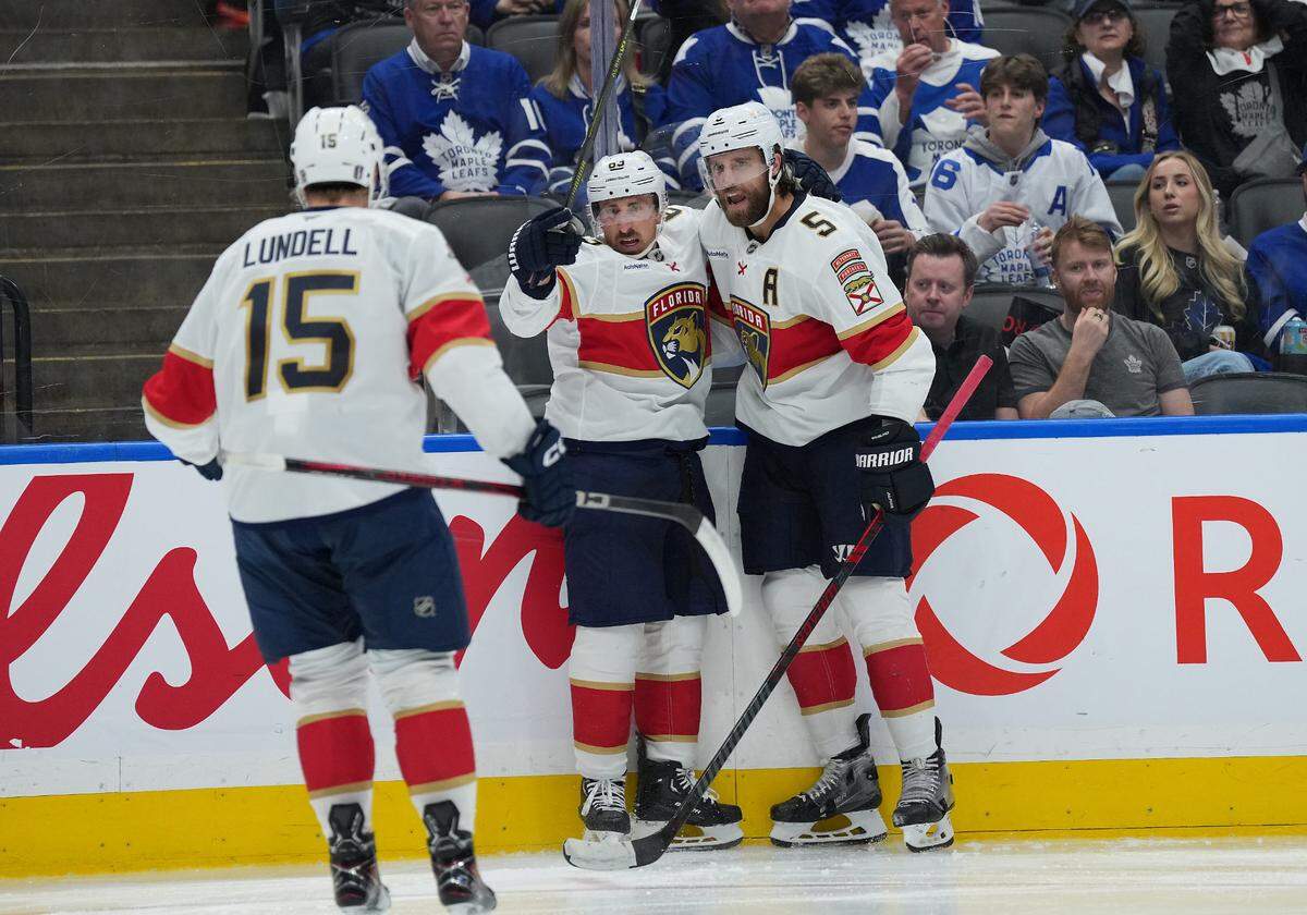 May 7, 2025; Toronto, Ontario, CAN; Florida Panthers center Brad Marchand (63) scores a goal and celebrates with defenseman Aaron Ekblad (5) against the Toronto Maple Leafs during the second period in game two of the second round of the 2025 Stanley Cup Playoffs at Scotiabank Arena. Mandatory Credit: Nick Turchiaro-Imagn Images