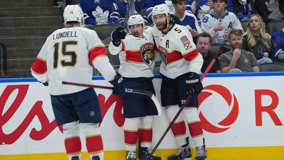 May 7, 2025; Toronto, Ontario, CAN; Florida Panthers center Brad Marchand (63) scores a goal and celebrates with defenseman Aaron Ekblad (5) against the Toronto Maple Leafs during the second period in game two of the second round of the 2025 Stanley Cup Playoffs at Scotiabank Arena.