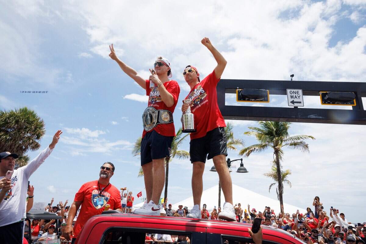Florida Panthers left wing Matthew Tkachuk (19) and Sam Reinhart (13) wave to fans during the Florida Panthers Stanley Cup Championship victory parade on Sunday, June 22, 2025 down Las Olas in Fort Lauderdale, Fla.