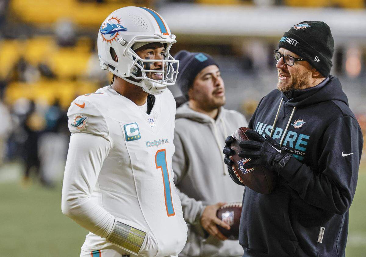 Miami Dolphins quarterback Tua Tagovailoa and quarterback and pass game coordinator Darrell Bevell on the field before thier NFL football game against the Pittsburgh Steelers at Acrisure Stadium in Pittsburgh, PA., on Monday, December 15, 2025.