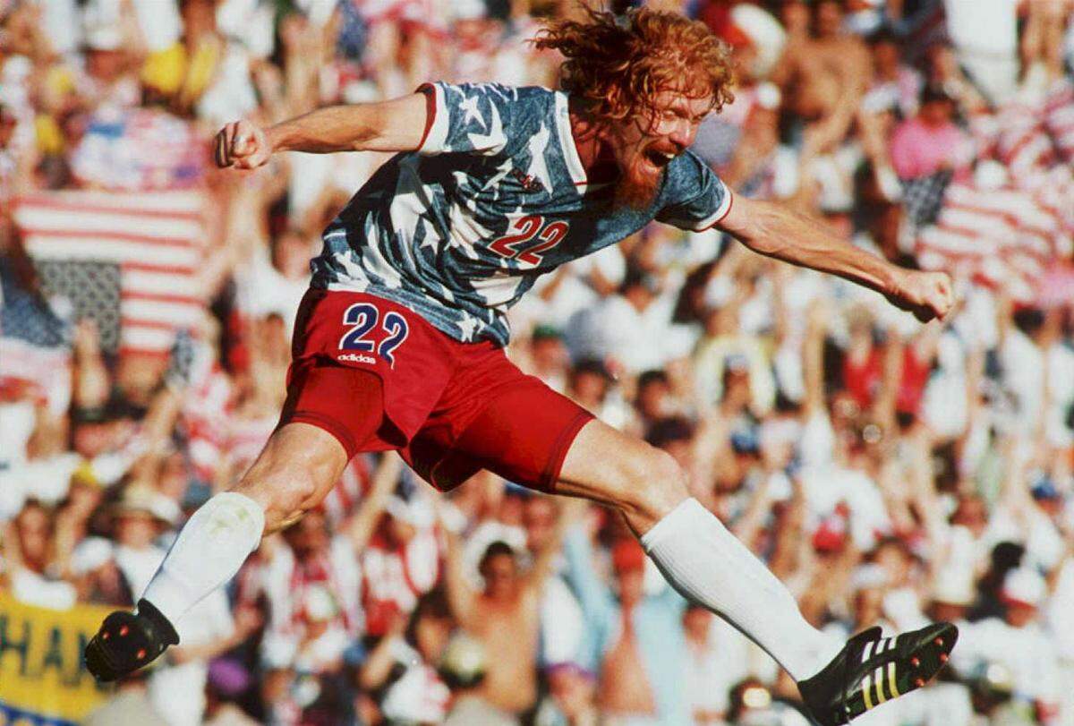 FILES,- JUNE 22:  US national team defender Alexi Lalas jumps in the air 22 June 1994 as he celebrates after the US defeated Colombia in their World Cup match at the Rose Bowl in Pasadena, California. The US won their match 2-1.  (Photo credit should read PATRICK HERTZOG/AFP via Getty Images)