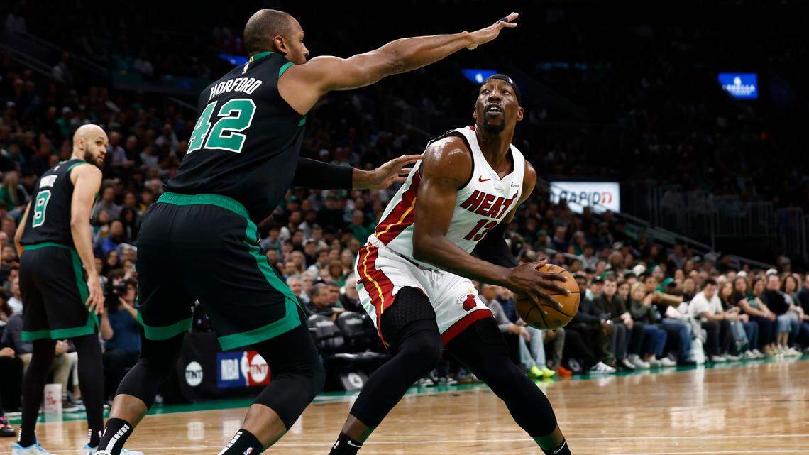 Miami Heat center Bam Adebayo (13) looks for a way around Boston Celtics center Al Horford (42) during the first quarter of game five of the first round of the 2024 NBA playoffs at TD Garden.