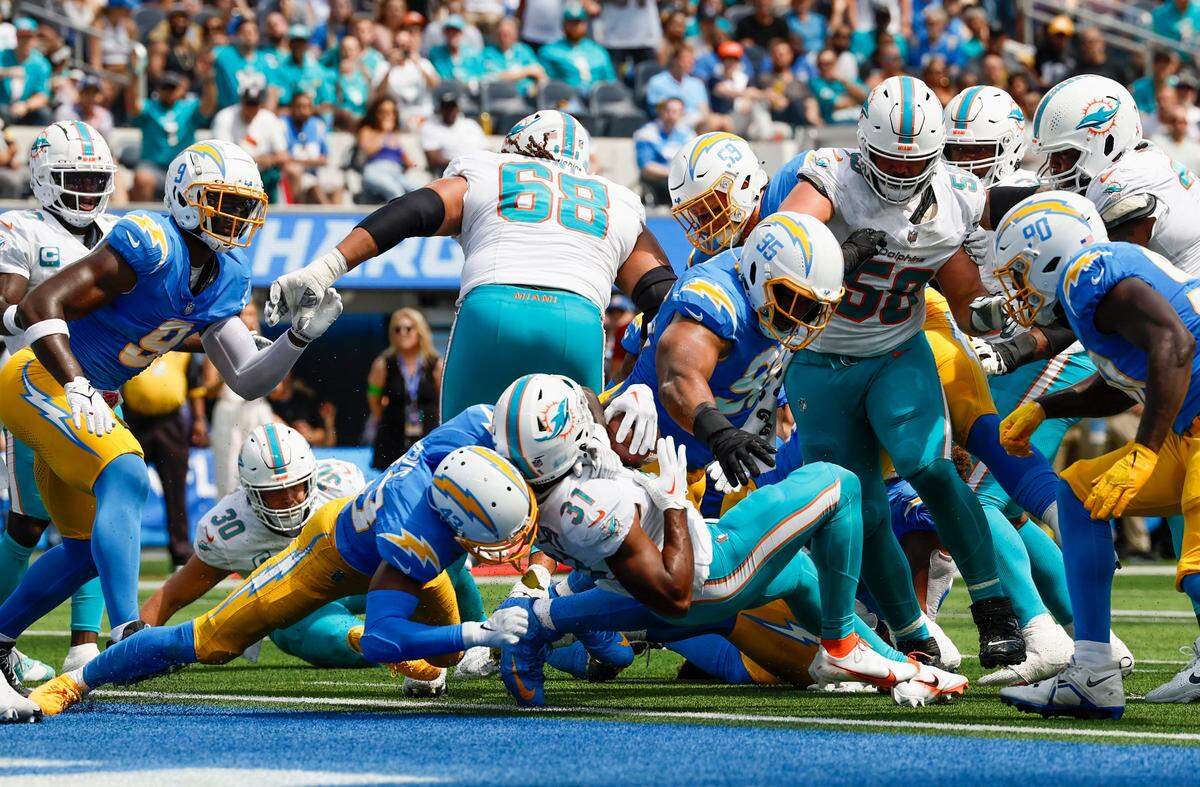 Miami Dolphins running back Raheem Mostert (31) runs for a touchdown against Los Angeles Chargers during first quarter of an NFL football game at SoFi Stadium in Inglewood, California on Sunday, September 10, 2023.