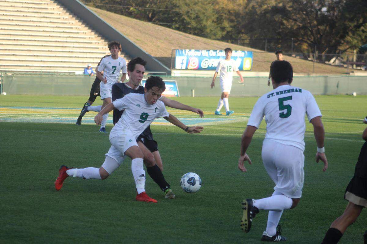 St. Brendan’s Julian Vazquez (9) chases down a loose ball as Bishop Moore defenders pursue in Thursday’s Class 4A state championship game at Spec Martin Stadium in DeLand.