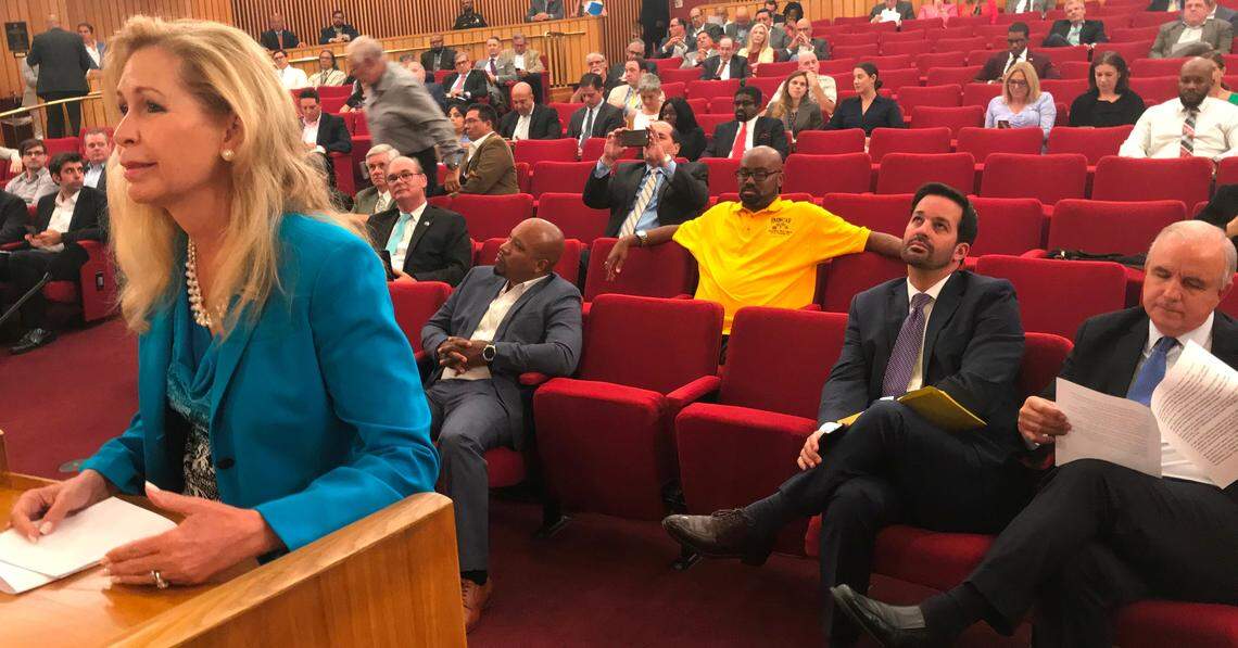 Cutler Bay Mayor Peggy Bell urges a Miami-Dade transportation board to endorse extending Metrorail to her city as part of a 20-mile extension. The Transportation Planning Organization endorsed a 20-mile rapid-transit bus system instead. Seated at the far right is Miami-Dade Mayor Carlos Gimenez, who championed the bus plan. Next to him is Alex Ferro, the mayor’s chief of staff.
