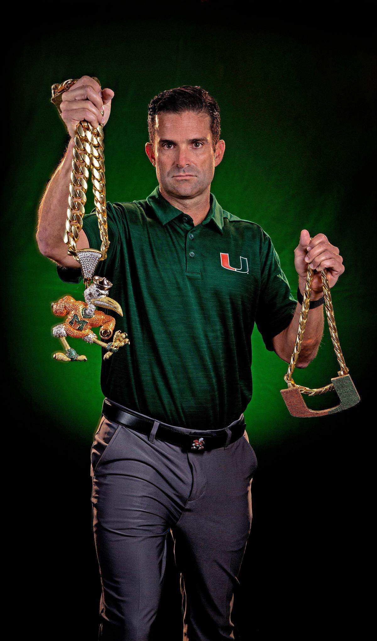 The University of Miami Hurricanes coach, Manny Diaz holds the football team’s Turn Over Chains on Tuesday, August 13, 2019. The original Turnover Chain at right is 36 Inches long & weighs 5.5 pounds. The 2018 version of the chain has Sebastian the Ibis at 8.5 inches, about three inches longer than the U, and features more than 4,000 stones.