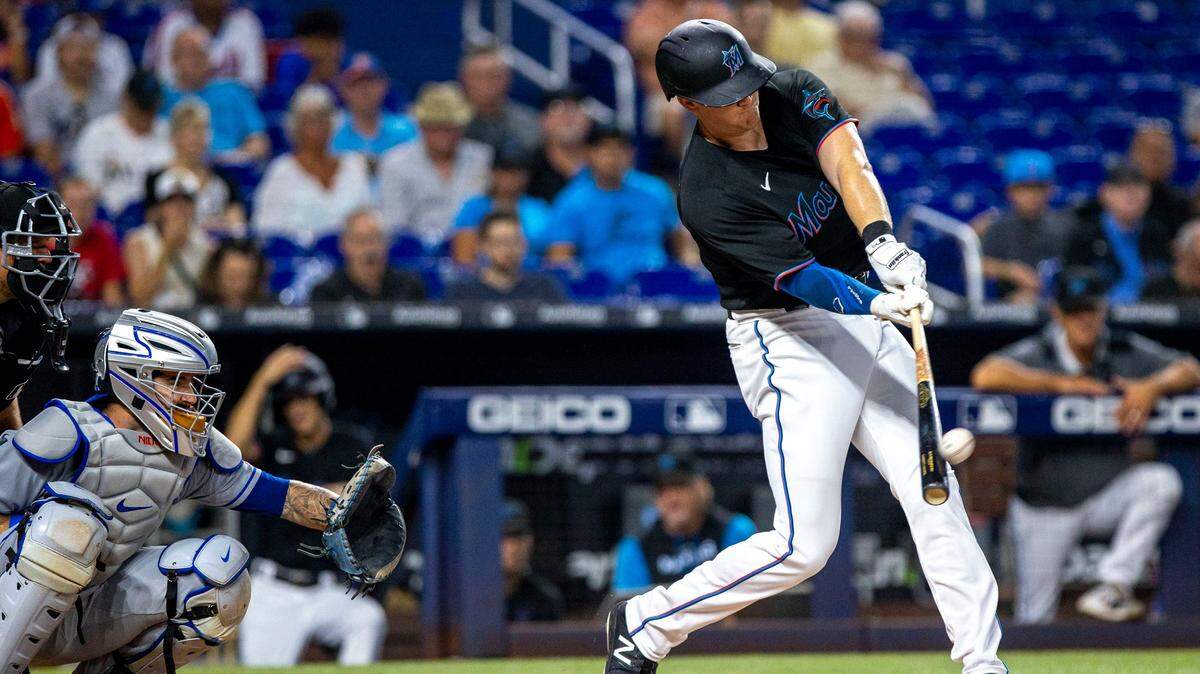 Miami Marlins batter Garrett Cooper (26) hits a two-run home run during the first inning of an MLB game against the New York Mets at loanDepot park in the Little Havana neighborhood of Miami, Florida, on Friday, September 9, 2022.