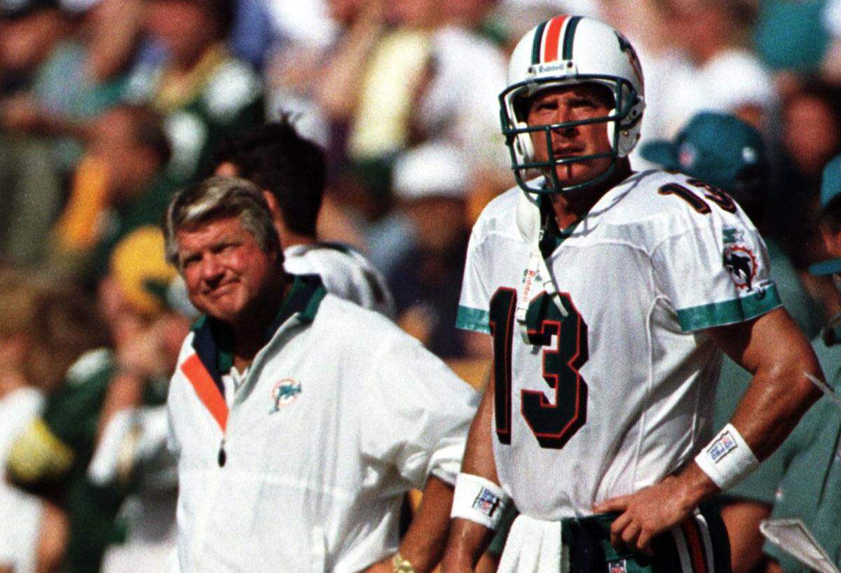 Dolphins coach Jimmy Johnson & QB Dan Marino watch from the sideline.