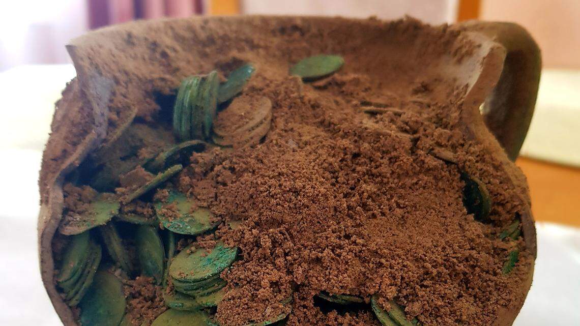 A man was looking for a lost machine part in a field in Zaniówka when he found a centuries-old stash with hundreds of coins, photos show.