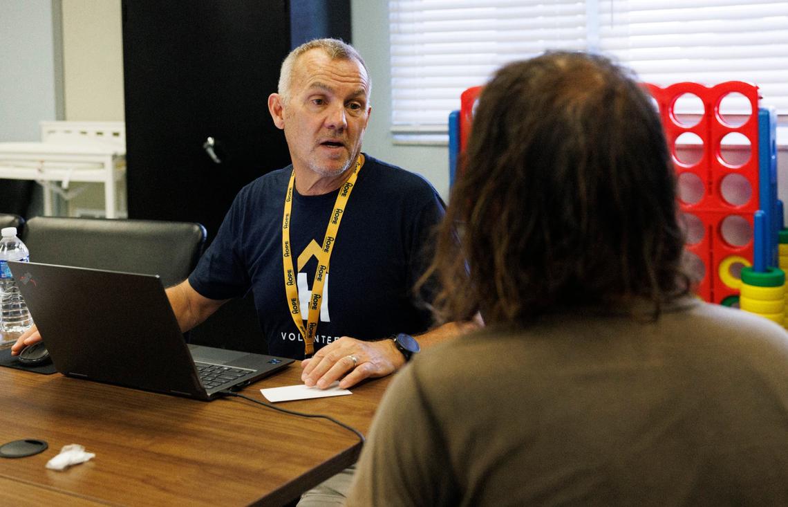 Tony, a HOPE South Florida worker, helps people register for food stamps during lunch time on Thursday, Sept. 5, 2024, at HOPE South Florida in Fort Lauderdale. People can get mail, like food stamps, delivered to HOPE.