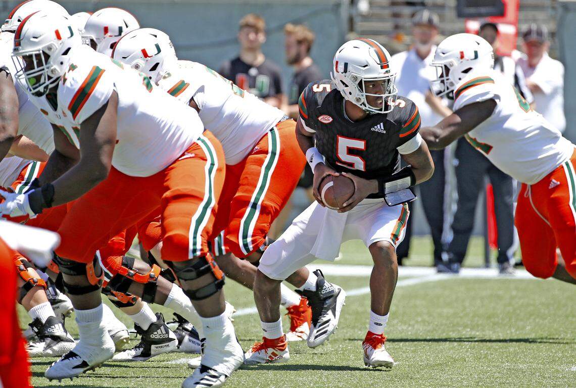 Miami Hurricanes quarterback N’Kosi Perry (5) looks to hand off the ball during the Miami Hurricanes spring game at Camping World Stadium in Orlando on Saturday, April 20, 2019.