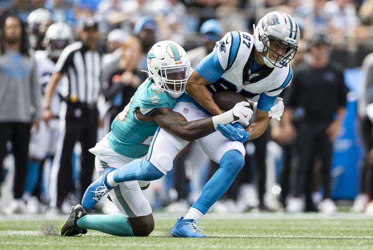 Miami Dolphins cornerback Rasul Douglas (26) tackles Carolina Panthers wide receiver Brycen Tremayne (87) in the second half of their NFL game at the Bank of America Stadium on Sunday, Oct. 5, 2025, in Charlotte, N.C.