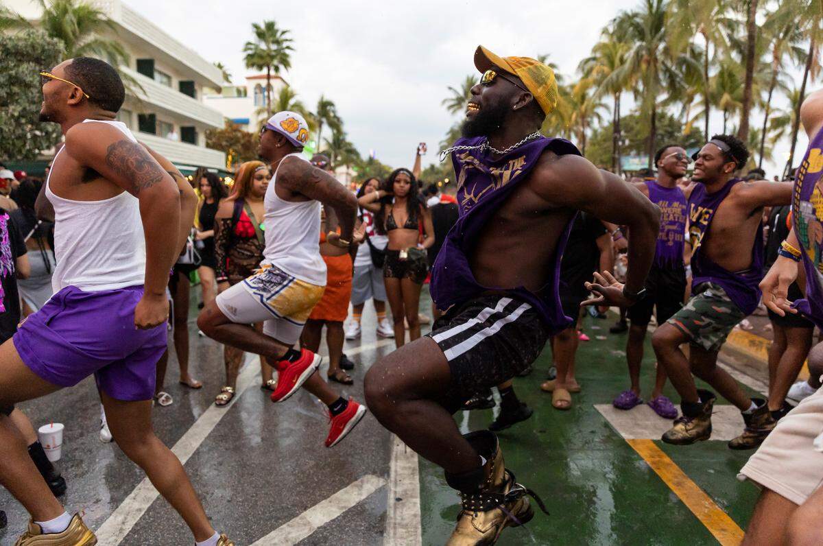 Dayo Akinwole, center, dances with fellow members of Omicron Delta Chapter of Omega Psi Phi on Ocean Drive during spring break on Saturday, March 11, 2023, in Miami Beach, Fla.