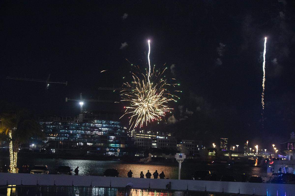 People watch a midnight fireworks display over Biscayne Bay during the New Year’s Eve celebration at Bayfront Park on Dec. 31, 2025, in Miami, Florida.