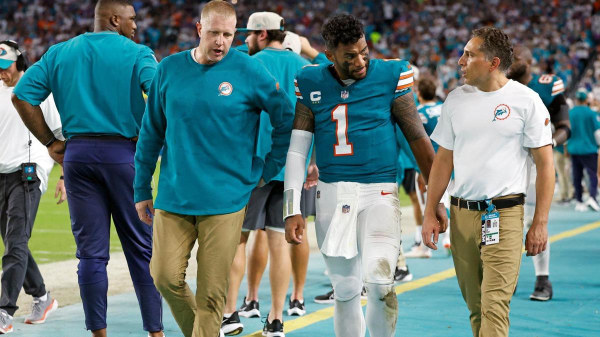 Miami Dolphins quarterback Tua Tagovailoa (1) is assisted off the field in the third quarter after an injury during the game against the Buffalo Bills in an NFL game at Hard Rock Stadium on Thursday, September 12, 2024.