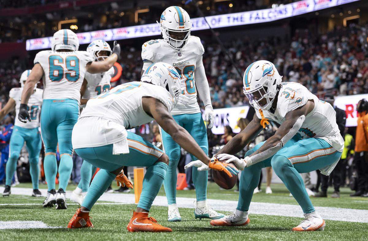 Miami Dolphins running back Ollie Gordon II (31) celebrates with wide receiver Jaylen Waddle (17) after scoring a touchdown against the Atlanta Falcons in the second half of their NFL game at Mercedes-Benz Stadium on Sunday, Oct. 26, 2025, in Atlanta, Ga.