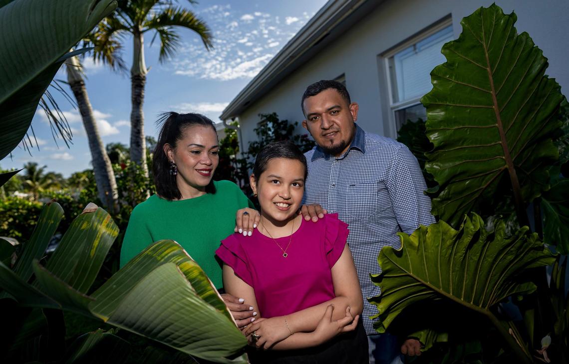 Elizabeth Izaguirre, 10, who has been receiving cancer treatment at Nicklaus Children’s Hospital, is photographed alongside her parents, Heidi Gomez, 42, and Yony Izaguirre, 36.