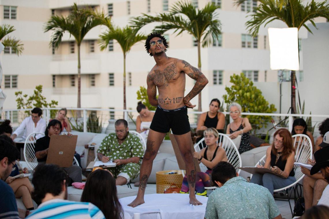 Artist Mychal Clayton poses as people make figure drawings of him at at Hotel Greystone during the Raw Figs Pop Up in Miami Beach, Florida on Wednesday, August 25, 2022.