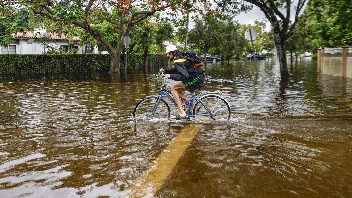 Carlos Armstrong,25, rides to his damaged home by flood waters near NE 123 street and 11th Court in North Miami on Thursday, June 13, 2024.