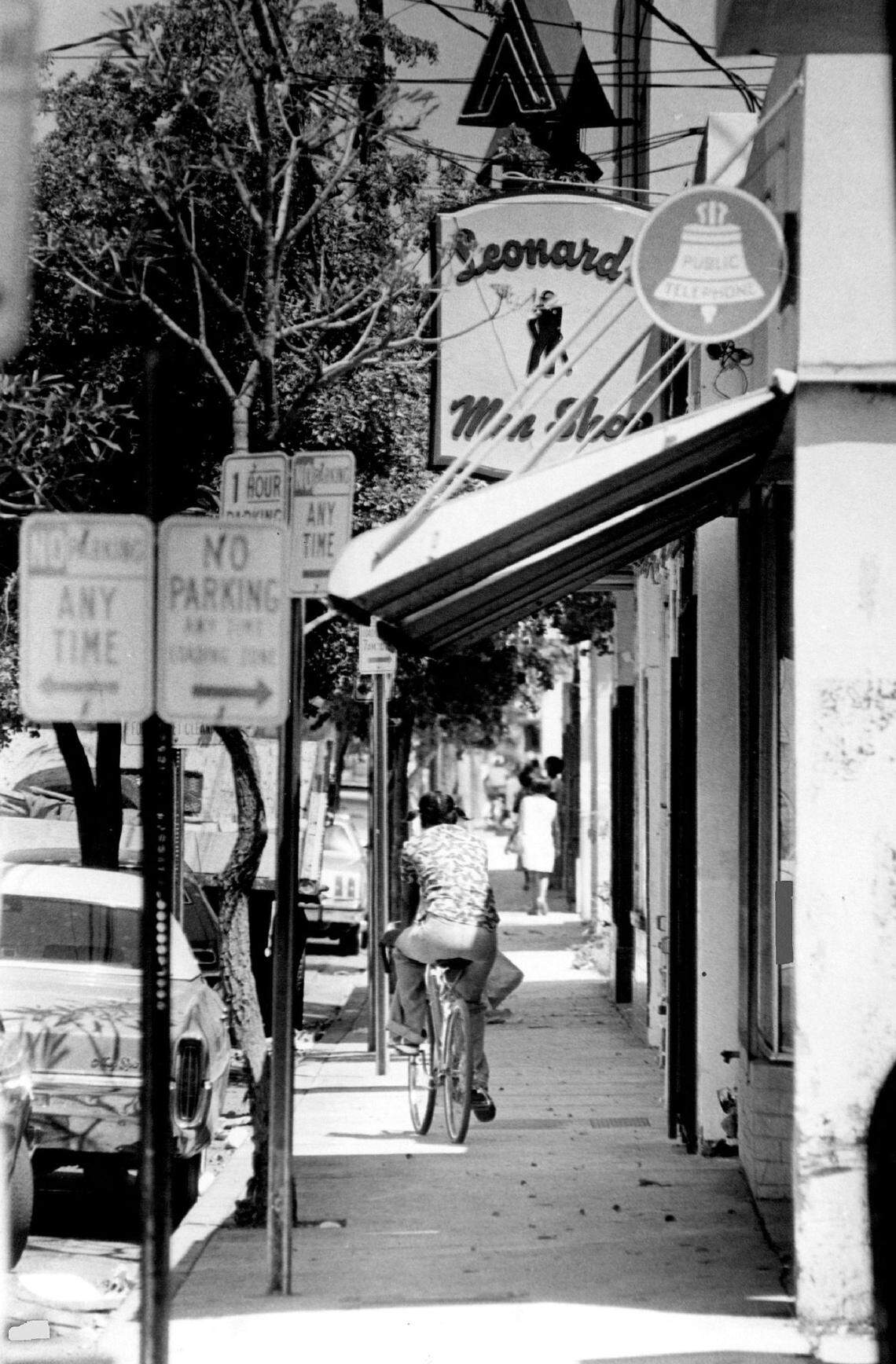 Grand Avenue was long the commercial heart of the historically Black section of Miami’s Coconut Grove. A sign for a long-gone men’s tailor shop is visible above the sidewalk cyclist.