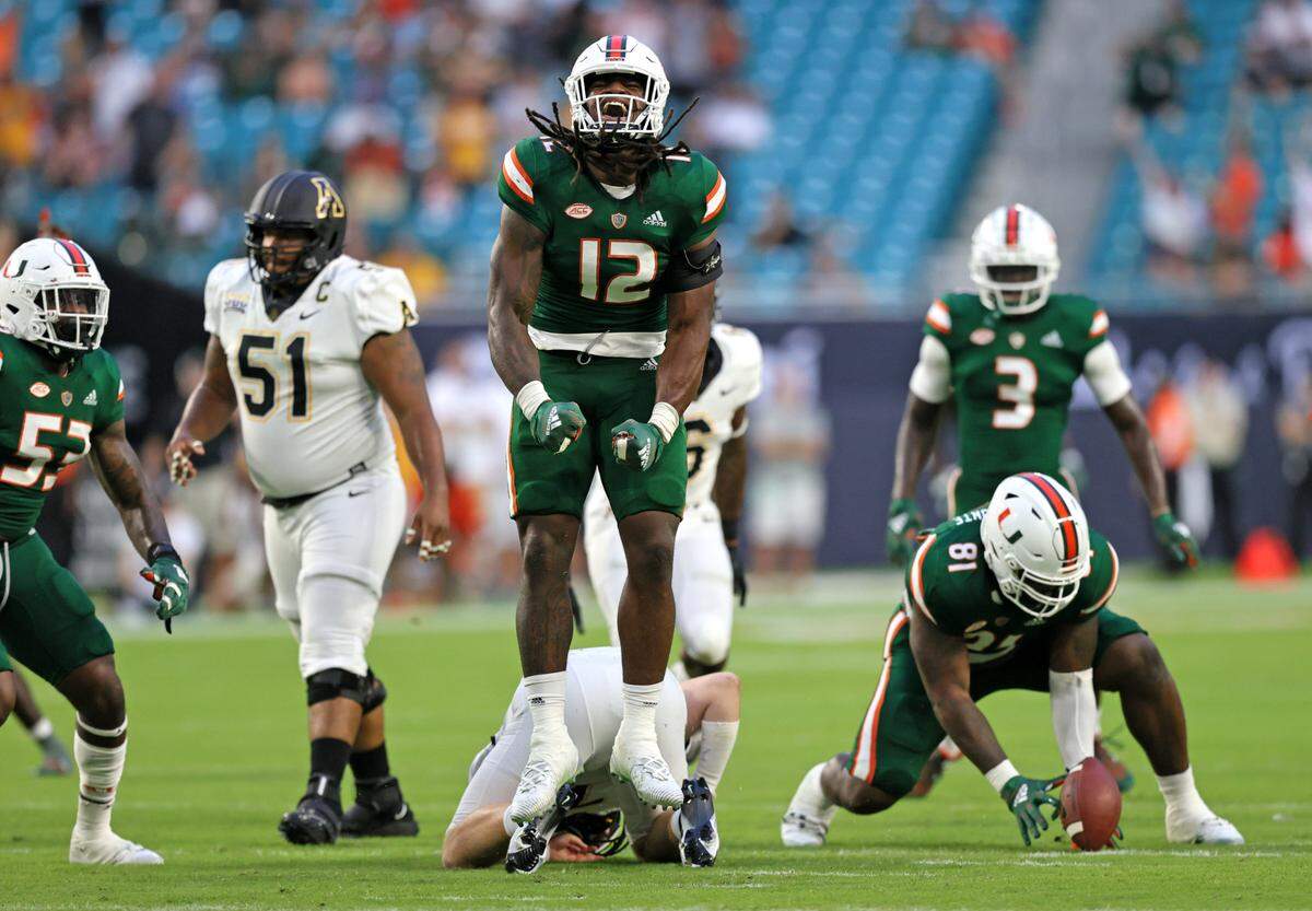 Miami Hurricanes defensive lineman Jahfari Harvey (12) reacts after sacking Appalachian State Mountaineers quarterback Chase Brice (7) during the first quarter of their ACC football game at Hard Rock Stadium on Saturday, September 11, 2021 in Miami Gardens, Florida.