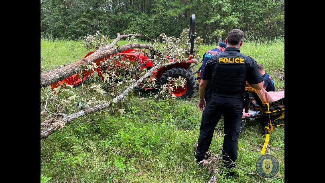 A man was trapped after a fallen tree pinned him to the seat of a tractor in Florida, according to the Alachua Police Department.