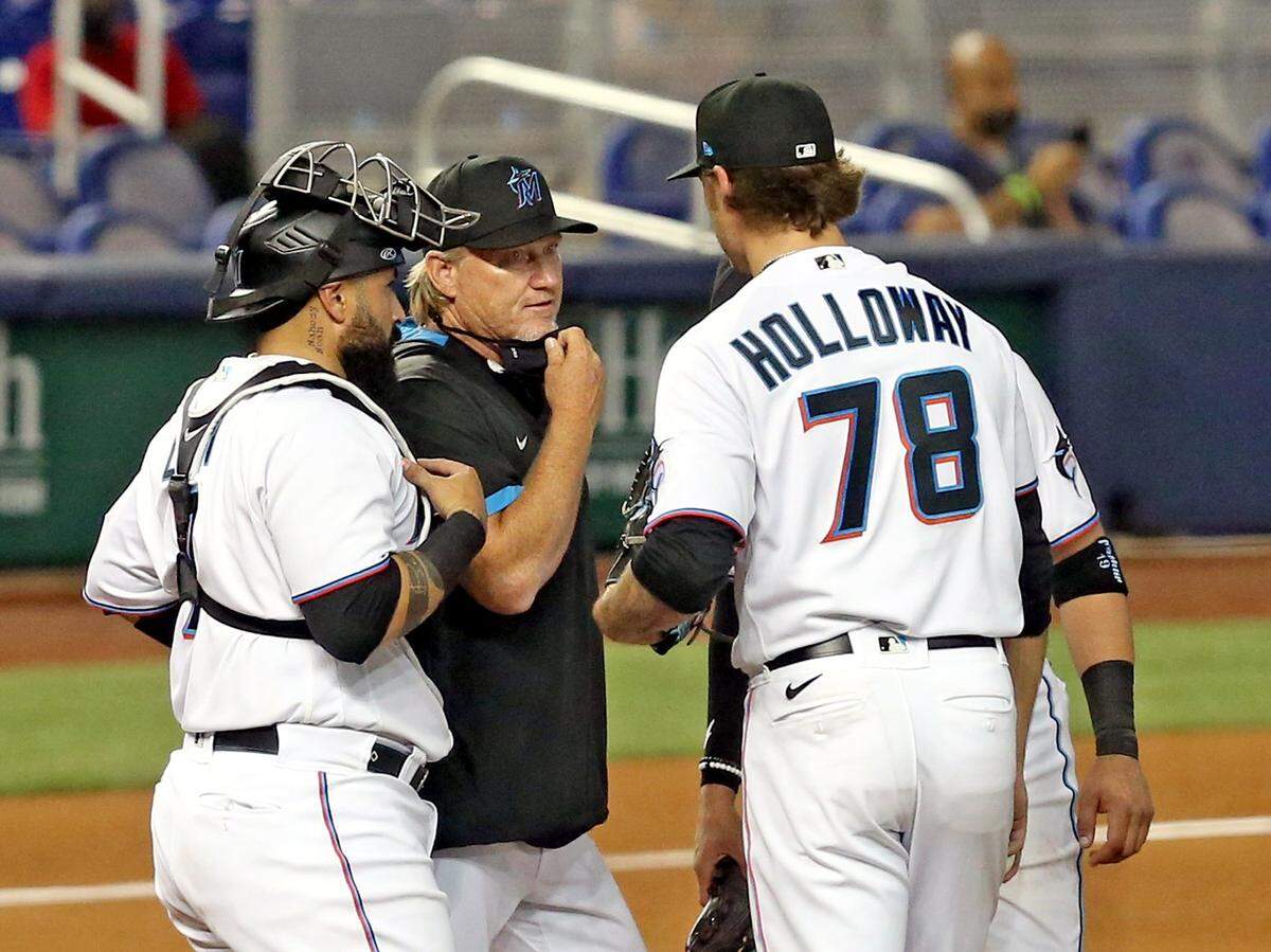 Miami Marlins manger Don Mattingly talks with pitcher Jordan Holloway (78) on the mound as they play the Arizona Diamondbacks in the fourth inning at loanDepotpark in Miami, Florida, Wednesday, May 5, 2021.