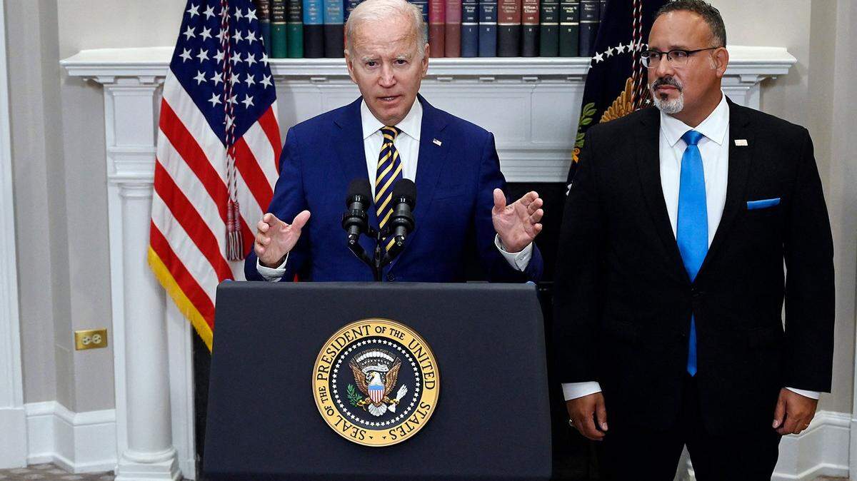 US President Joe Biden announces student loan relief with Education Secretary Miguel Cardona (right) on Aug. 24, 2022, in the Roosevelt Room of the White House in Washington, DC. (Olivier Douliery/AFP via Getty Images/TNS)