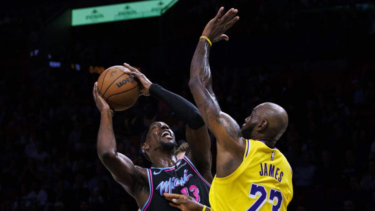 Miami Heat center Bam Adebayo (13) looks for the basket over Los Angeles Lakers forward LeBron James (23) during the first half of a game on Thursday, March 19, 2026, at Kaseya Center in Miami.