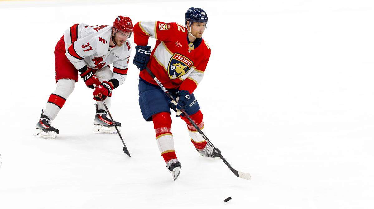 Florida Panthers defenseman Gustav Forsling (42) controls the puck while being defended by Carolina Hurricanes right wing Andrei Svechnikov (37) during the second period of Game 3 in the Eastern Conference Final of the NHL Stanley Cup Playoffs at Amerant Bank Arena on Saturday, May 24, 2025, in Sunrise, Fla.