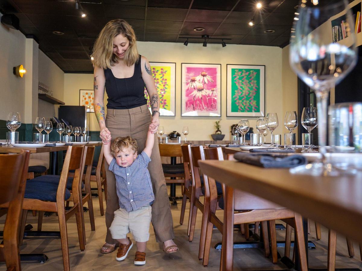 Katherine Mederos, 25, plays with her 21-month-old son, Jameson, inside Kojin 2.0, which has taken over the former space of The Lion & The Rambler and Eating House.