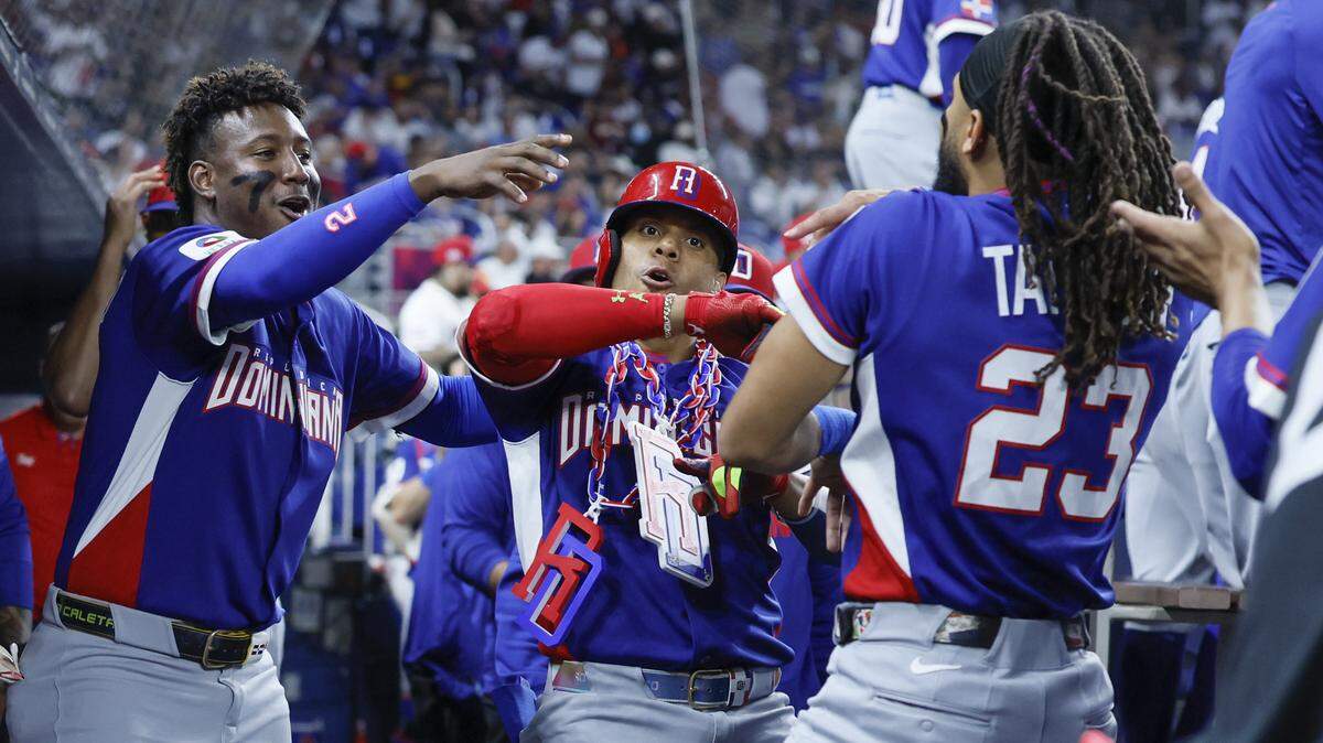 Dominican Republic right fielder Juan Soto (22), seen at center, celebrates in the dugout with teammates after scoring a homerun against Venezuela in the third inning during the World Baseball Classic at loanDept park on Wednesday, March 11, 2026. 