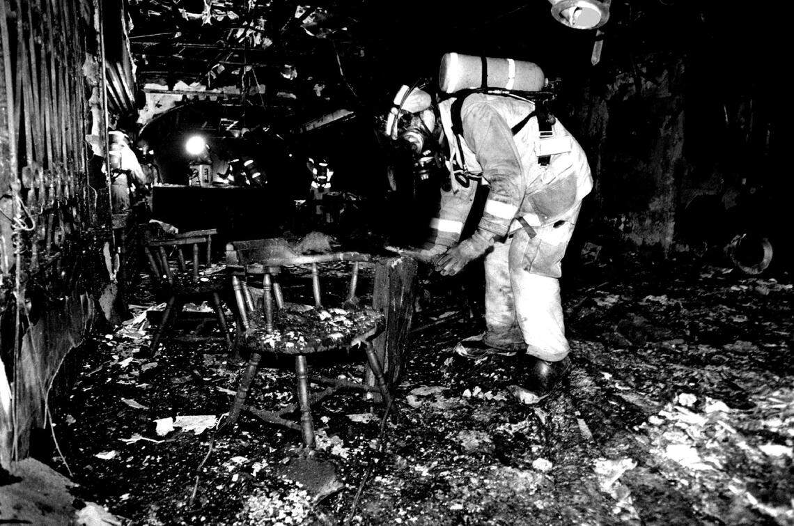 A firefighter goes through debris in the Flamenco supper club on 79th Street in Miami. restaurant which was destroyed by a 1984 blaze..