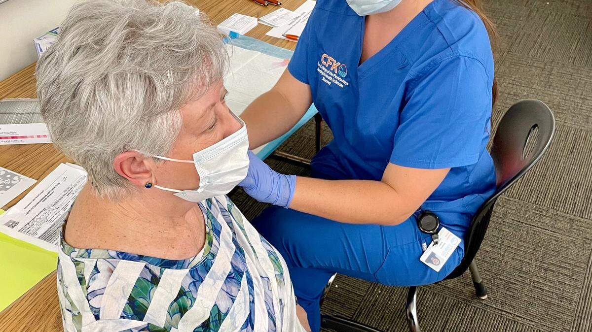 Victoria Bailey, a student nurse at the College of the Florida Keys, vaccinates retired elementary school teacher Georgia Parks at CFK’s mass vaccine event on Feb. 7.