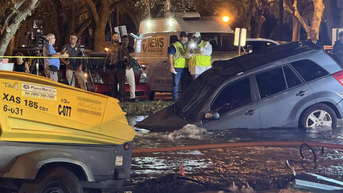 An SUV was partially submerged after contractors hit a water main in Miami Lakes on Monday, Feb. 26, 2024.