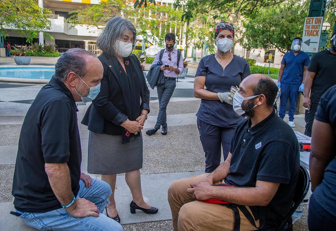 From left: Ron L. Book, Chair of the Homeless Trust and Miami-Dade County Mayor Daniella Levine Cava, talk to Uberne Vargas, a homeless man in downtown Miami after he got vaccinated against COVID-19 during the vaccination tour across Miami-Dade.